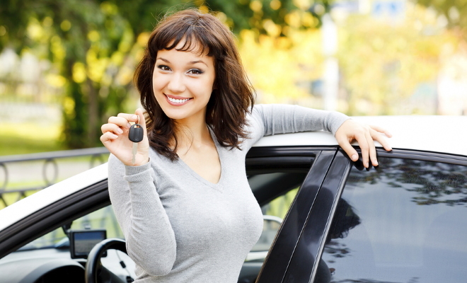 smiling girl holding car keys